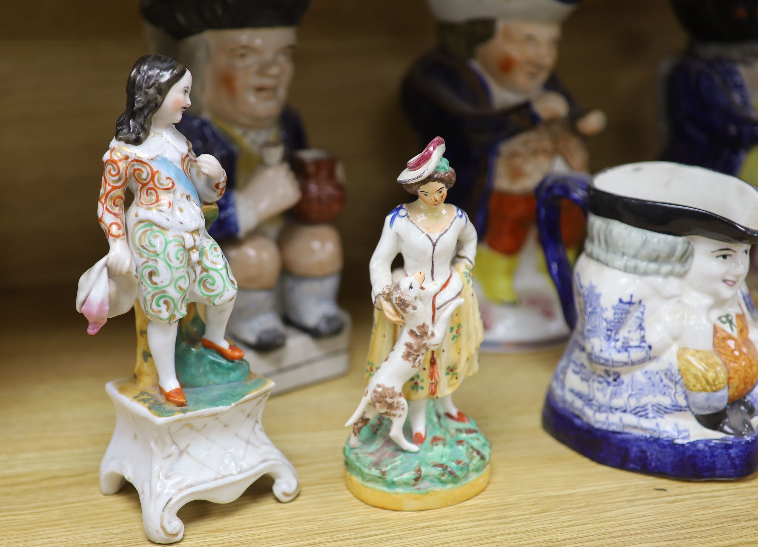 A quantity of Staffordshire pottery, including four Toby jugs, four figures, a copper lustre jug and a silver resist jug (10)